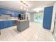 Bright eat-in kitchen featuring blue cabinetry, stainless steel appliances, and tile floors at 3051 Dairy Farm Dr, Monroe, NC 28110
