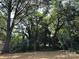 A spacious backyard lot with plenty of mature trees providing generous shade at 307 Wilson St, Monroe, NC 28112