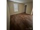 A cozy bedroom with wood-look flooring and a neutral color palette and natural light at 307 Wilson St, Monroe, NC 28112