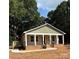 Charming home showcasing a porch and a small deck attached to the side at 307 Wilson St, Monroe, NC 28112