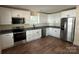Modern kitchen with stainless steel appliances, granite countertops, and white cabinets at 307 Wilson St, Monroe, NC 28112