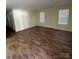 Bright living room with wood flooring and two windows offering plenty of natural light at 307 Wilson St, Monroe, NC 28112