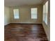 Bright living room featuring wood-look floors and plenty of natural light from large windows at 307 Wilson St, Monroe, NC 28112
