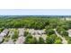 Aerial view showcases several homes surrounded by lush green trees and landscaping within a suburban neighborhood at 3247 Mannington Dr, Charlotte, NC 28270