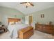 Spacious bedroom featuring a queen bed, dresser, and a ceiling fan at 3247 Mannington Dr, Charlotte, NC 28270
