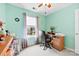 Bright bedroom features a desk, ceiling fan, natural light from the window, and neutral carpet at 3247 Mannington Dr, Charlotte, NC 28270