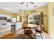 Bright dining area with wood-look flooring, views of the backyard, and adjacent kitchen access at 3247 Mannington Dr, Charlotte, NC 28270