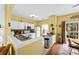 Efficient kitchen with white cabinets, functional appliances, and a view into the dining area at 3247 Mannington Dr, Charlotte, NC 28270