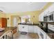 Functional kitchen with white cabinets, a breakfast bar, and a view to the living area at 3247 Mannington Dr, Charlotte, NC 28270