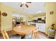 Open kitchen/dining area with white cabinets, dining table and view to the living room at 3247 Mannington Dr, Charlotte, NC 28270