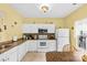 Well-lit kitchen with white cabinets, tile floors, and essential appliances at 3247 Mannington Dr, Charlotte, NC 28270