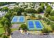 Aerial view of community tennis courts and a basketball court with parking and surrounding landscaping at 3247 Mannington Dr, Charlotte, NC 28270