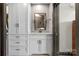 Well-lit bathroom with gray shaker cabinets, black hardware, and granite countertops at 333 W Trade St # 1106, Charlotte, NC 28202
