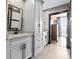 Well-lit bathroom with gray shaker cabinets, black hardware, and granite countertops at 333 W Trade St # 1106, Charlotte, NC 28202