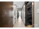 Hallway featuring gray shaker cabinets, tile floors, sliding doors, and stackable laundry set at 333 W Trade St # 1106, Charlotte, NC 28202