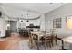Open-concept living area with the kitchen, featuring warm lighting, stylish rug, and dining set at 333 W Trade St # 1106, Charlotte, NC 28202