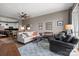 A bright living room with ceiling fan, wooden floor, area rug and neutral-colored walls at 333 W Trade St # 1106, Charlotte, NC 28202