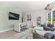 Bright living room with modern décor, bar seating, and large windows for ample natural light at 333 W Trade St # 1106, Charlotte, NC 28202