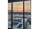 Enjoy captivating sunset views through expansive windows, showcasing the horizon from this high rise condo at 333 W Trade St # 1106, Charlotte, NC 28202