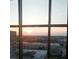 A stunning sunset view from a large window with a great view overlooking the city and horizon at 333 W Trade St # 1106, Charlotte, NC 28202
