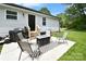 Charming patio with modern chairs, a sleek fire pit, and a built-in barbeque area for outdoor enjoyment at 339 Brown Rd, China Grove, NC 28023