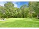 Expansive backyard with lush green grass, mature trees, and a patio area, ideal for outdoor activities at 339 Brown Rd, China Grove, NC 28023