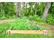 Charming garden area with raised beds and vibrant greenery, perfect for gardening enthusiasts at 339 Brown Rd, China Grove, NC 28023