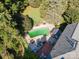 Aerial view of backyard with pool, wooden deck, patio, and lush landscaping at 3500 Cedar Springs Sw Dr, Concord, NC 28027