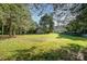 Wide, green backyard with storage sheds, and surrounded by mature trees at 3500 Cedar Springs Sw Dr, Concord, NC 28027