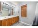 This bathroom has wood cabinets, a large mirror, and good lighting at 3500 Cedar Springs Sw Dr, Concord, NC 28027