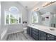 This bathroom is spacious with a dual vanity and arched windows at 3500 Cedar Springs Sw Dr, Concord, NC 28027