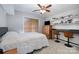 Cozy bedroom with natural light features neutral paint, shelving and work space at 3500 Cedar Springs Sw Dr, Concord, NC 28027