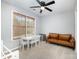 Bonus room with neutral paint, white table and a brown leather couch at 3500 Cedar Springs Sw Dr, Concord, NC 28027