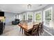 Open-concept dining room featuring hardwood floors, large windows, and a view of the backyard at 3500 Cedar Springs Sw Dr, Concord, NC 28027