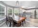 A dining room featuring many windows and a view into the kitchen with stainless steel appliances at 3500 Cedar Springs Sw Dr, Concord, NC 28027