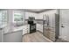 Bright kitchen with stainless steel appliances, granite countertops, and white cabinetry at 3500 Cedar Springs Sw Dr, Concord, NC 28027