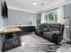 Comfortable living room featuring a modern sofa, large window, and gray walls at 3500 Cedar Springs Sw Dr, Concord, NC 28027