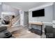 Living room featuring hardwood floors, a staircase, and neutral wall color at 3500 Cedar Springs Sw Dr, Concord, NC 28027