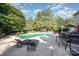 Backyard scene featuring a tranquil swimming pool, outdoor dining area, and lush landscaping at 3500 Cedar Springs Sw Dr, Concord, NC 28027