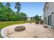 Spacious backyard with a stone fire pit, and a patio with a pergola and outdoor seating at 4151 Granite St, Midland, NC 28107