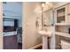Stylish powder room with a pedestal sink, decorative mirror, and convenient location at 4151 Granite St, Midland, NC 28107
