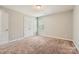 Bedroom featuring neutral-colored walls, carpet flooring, and a closet with white folding doors at 4151 Granite St, Midland, NC 28107