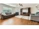 Spacious living room with a fireplace, built-in shelving, and comfortable seating arrangement at 4151 Granite St, Midland, NC 28107