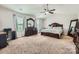 The expansive main bedroom offers lots of space, large windows, and a ceiling fan at 4151 Granite St, Midland, NC 28107