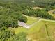 Aerial view of the property showcasing the home, large yard, surrounding trees, and driveway at 4330 Rowell Rd, Lancaster, SC 29720