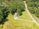 Aerial view of the home with an expansive green yard, surrounded by trees, and a long driveway at 4330 Rowell Rd, Lancaster, SC 29720
