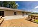 View of the brick home from the wooden deck, featuring benches and outdoor seating at 4330 Rowell Rd, Lancaster, SC 29720