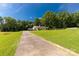 Sprawling property featuring a charming home, lush lawn, mature trees, and long driveway at 4330 Rowell Rd, Lancaster, SC 29720