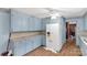 Functional kitchen with light blue cabinets, laminate flooring, and ample counter space providing an area for meal preparation at 4330 Rowell Rd, Lancaster, SC 29720