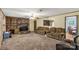 Cozy living room featuring a stone fireplace, plush carpeting, and a neutral color scheme with an adjoining dining space at 4330 Rowell Rd, Lancaster, SC 29720